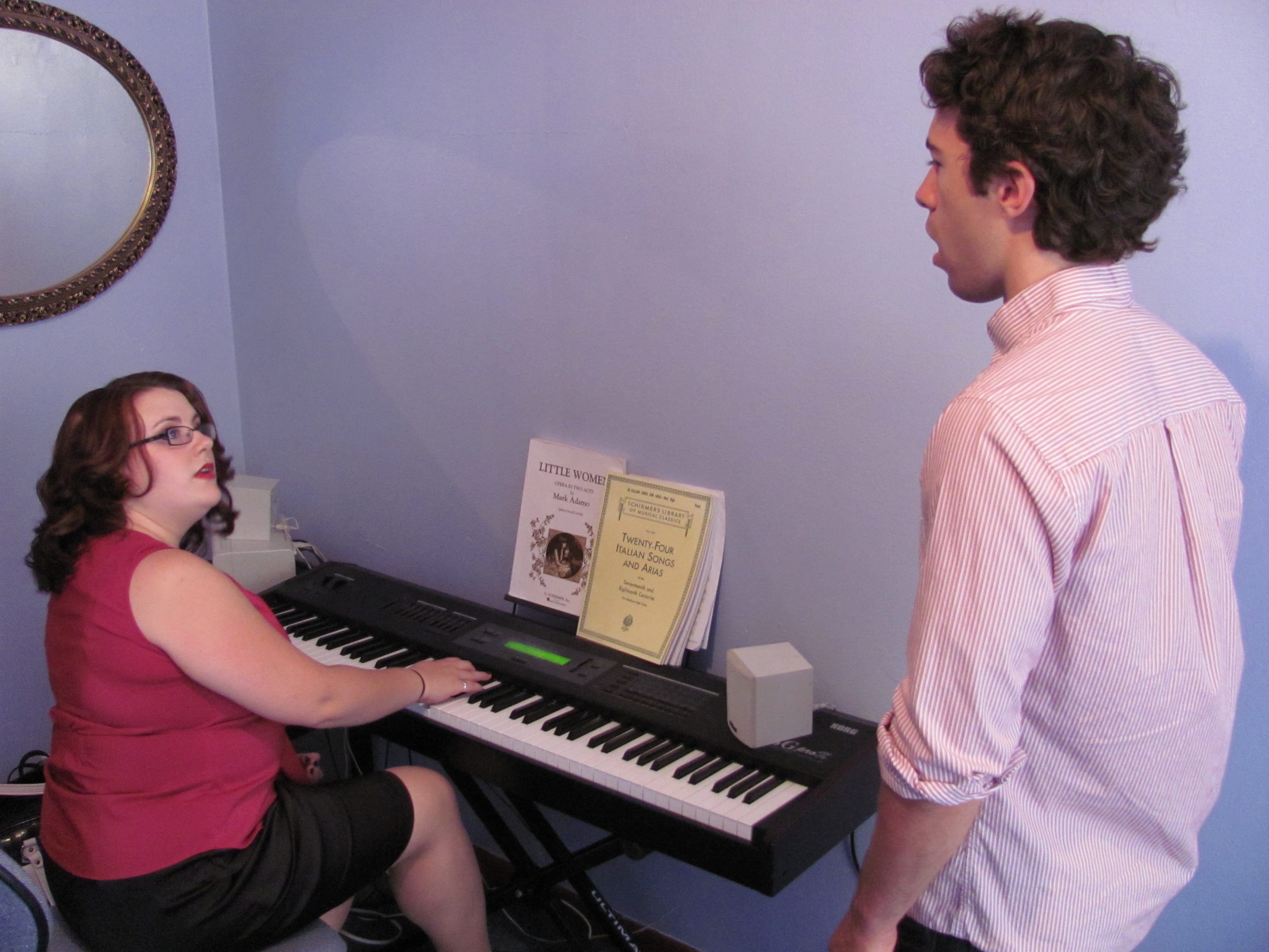Anne Maguire listens as Liam Tully works on breath control exercises at her office in downtown Camas. She graduated from The Boston Conservatory in May 2012.