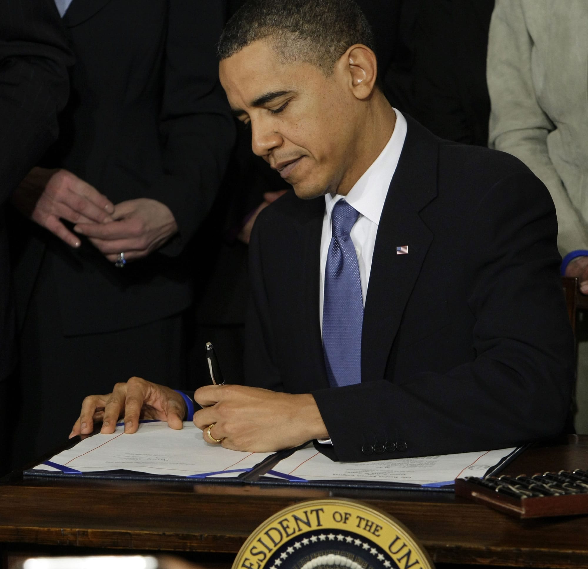 President Barack Obama signs the Affordable Care Act into law on March 23, 2010.