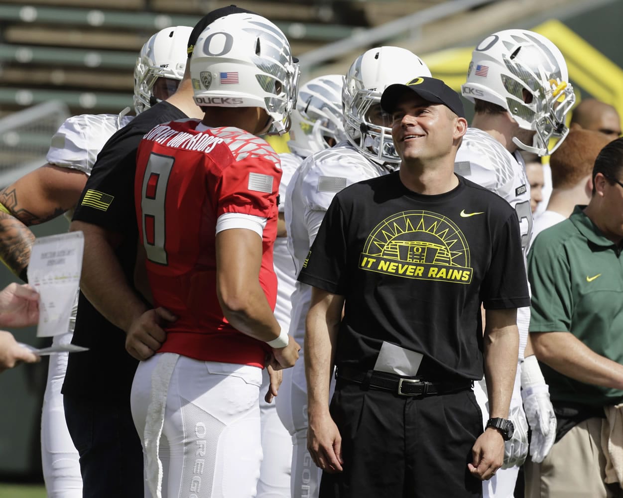 Oregon football coach Mark Helfrich, right, chats with quarterback Marcus Mariota during their spring NCAA college football game in Eugene, Ore. Helfrich has talked to predecessor Chip Kelly a bunch of times since Kelly bolted to the NFL. Kelly's advice? &quot;Be yourself,&quot; Helfrich said. &quot;If I can be known as the guy who kept winning after Chip Kelly, I'm good with that.&quot; The Ducks seemed primed to do so.