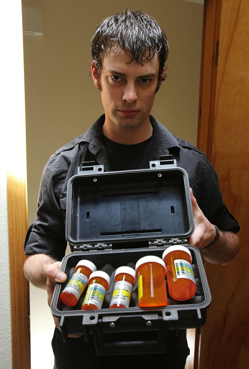 Jarrid Starks shows a collection of drugs prescribed before he left military service, in Salem, Oregon, August 3, 2012. He has recently run out of pills.