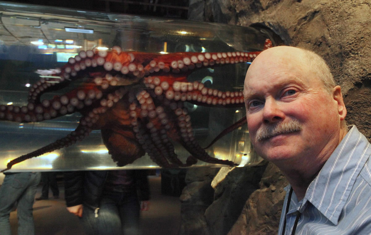 Roland Anderson stands near a giant Pacific octopus named Fifi at the Seattle Aquarium. Anderson retired in 2009 after decades as a biologist at the aquarium.