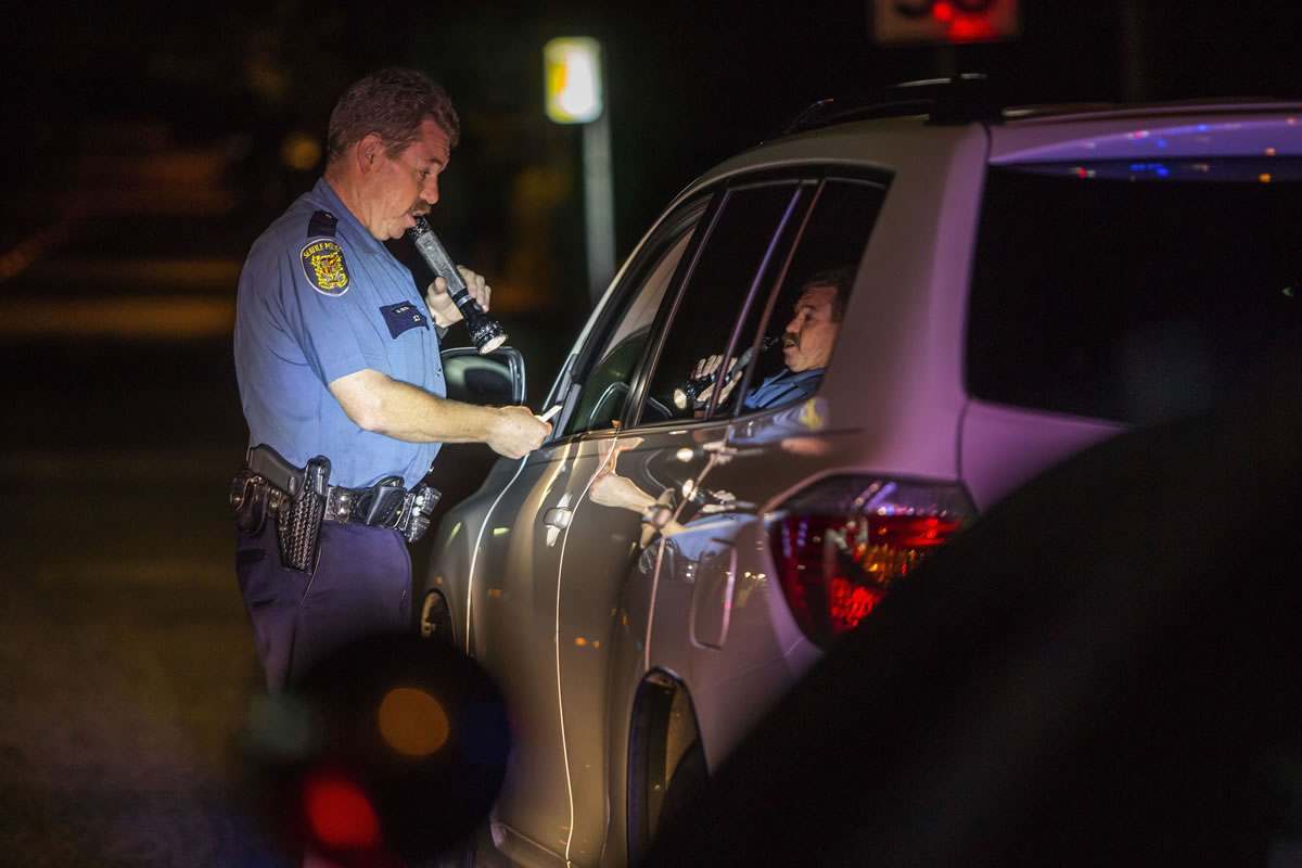 Seattle police Officer Mike Lewis, who is part of a group of more than 200 law-enforcement personnel around the state who have been specially trained to spot and evaluate motorists impaired by drugs and alcohol, makes a routine traffic stop on Aug.