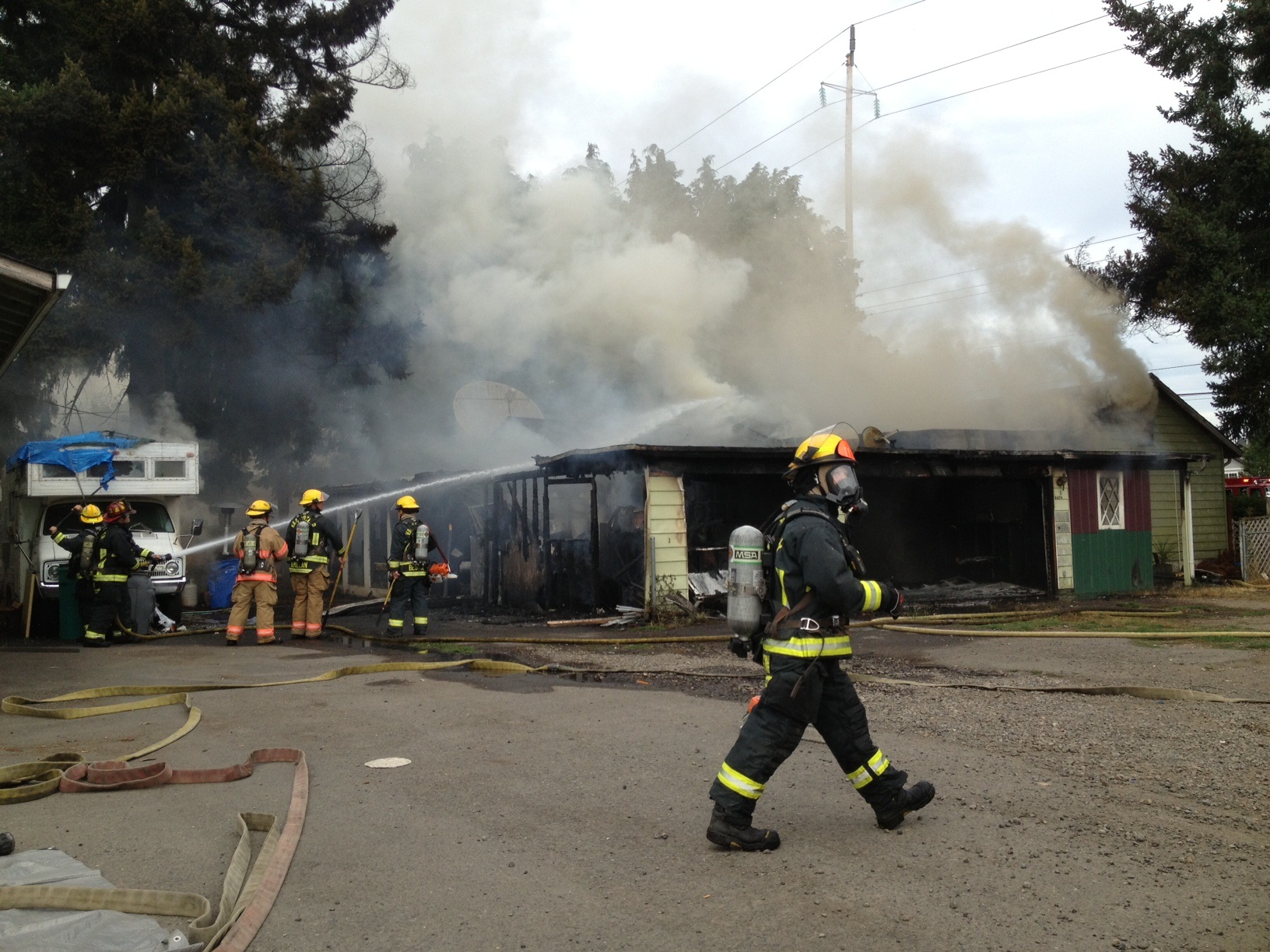 Firefighters battle a house fire in Vancouver's North Image neighborhood.