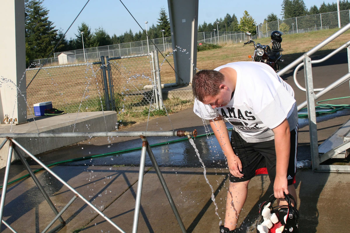 Jordan Downey lets the water drip down his face during a 98-degree day in Camas.