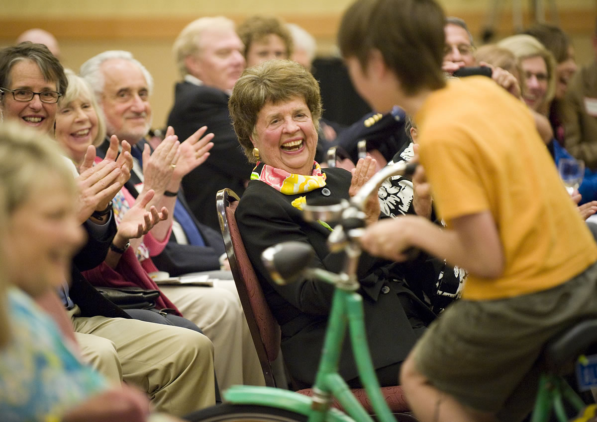 Florence Wager, center, was honored as Clark County's First Citizen for 2009 during a reception that included four cyclists who rode through as a nod to her role in establishing hiking trails and bike paths.