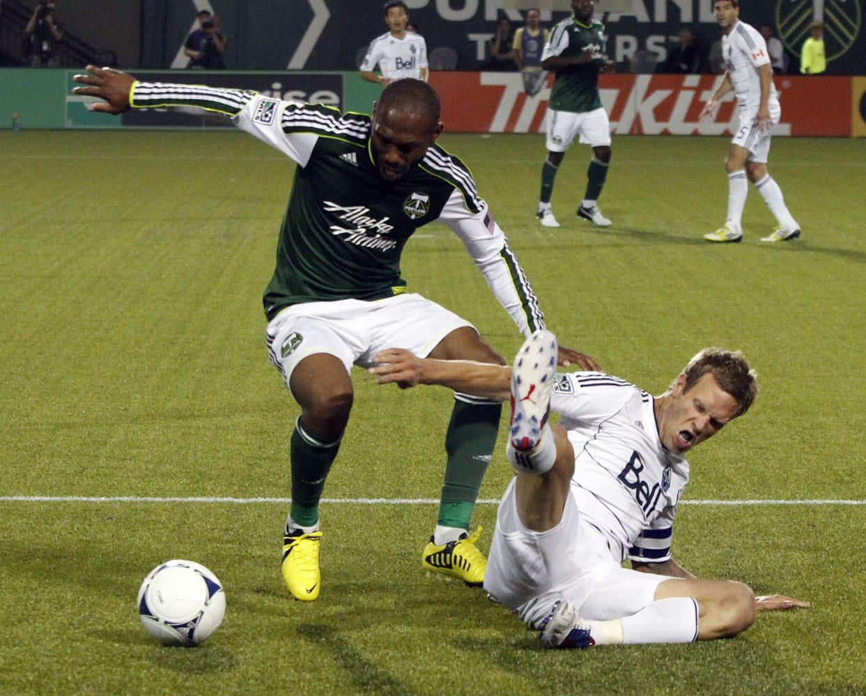 Portland's Franck Songo'o, left, steals the ball from Vancouver Whitecaps defender Jay Demerit during the second half Saturday.