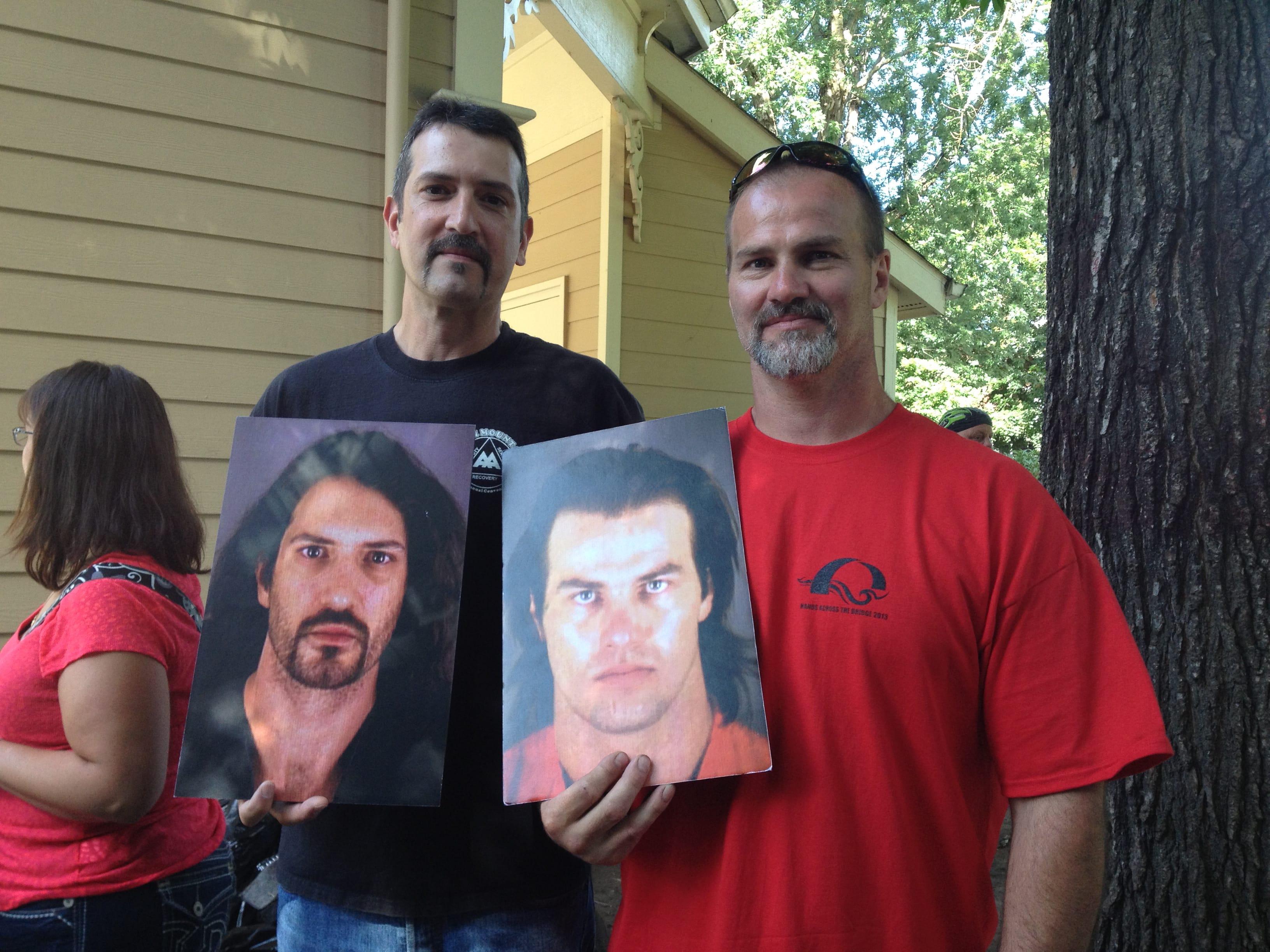 EMILY GILLESPIE/The Columbian 
 Shane Clark, 45, and Ken Jennings, 44, both of Vancouver hold up photos of their mug shots, each taken more than 10 years ago while they were doing methamphetamine. Clark is eight years clean and Jennings celebrated 10 years clean this year.