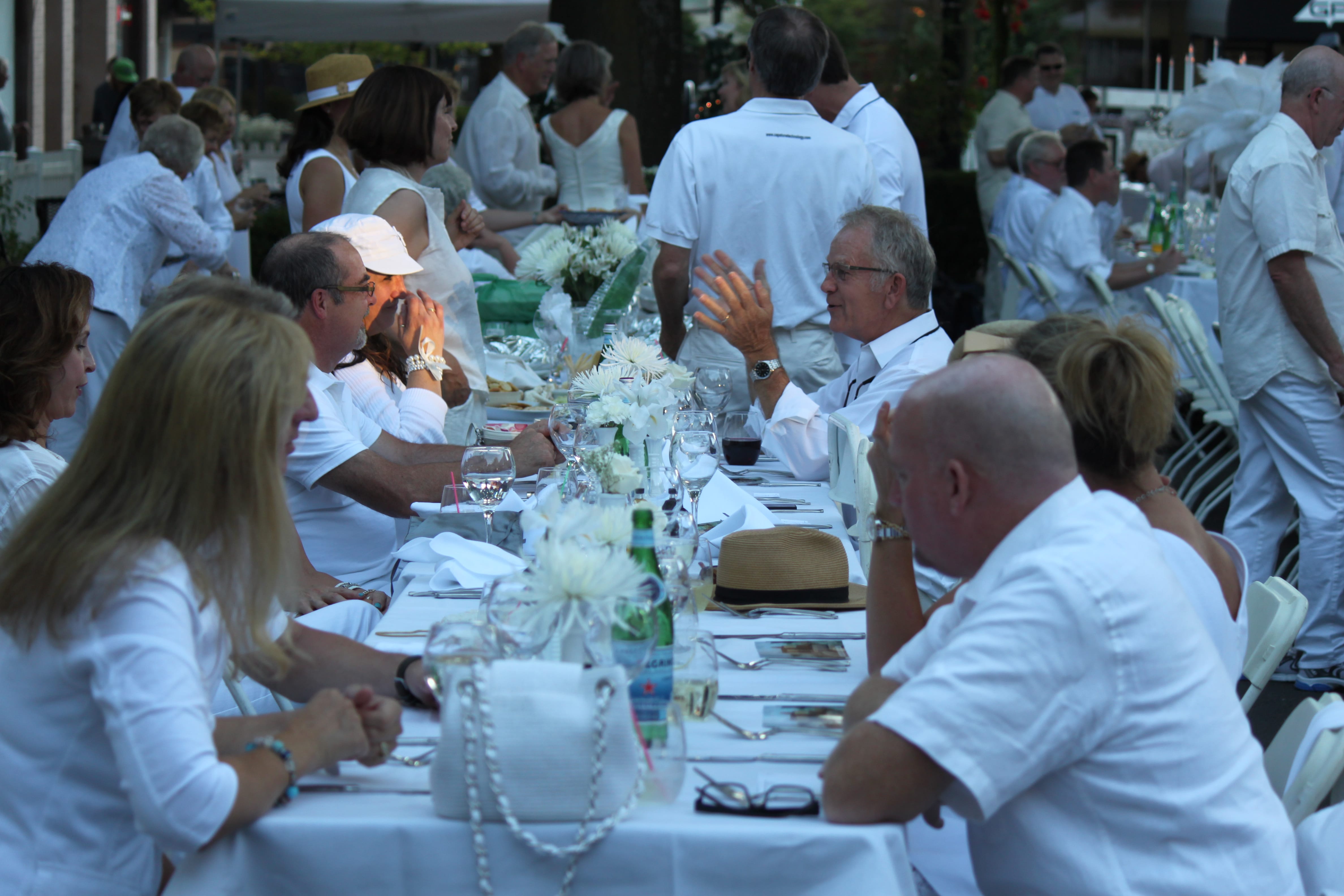 Friends and family enjoy food and drinks at the Camas in White event.
