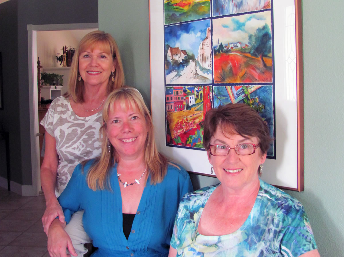 Kathy Sork, AnnaMarie &quot;Suzy&quot; Clement and Linda McCulloch (left to right) pose by a six-paneled group watercolor they helped create.