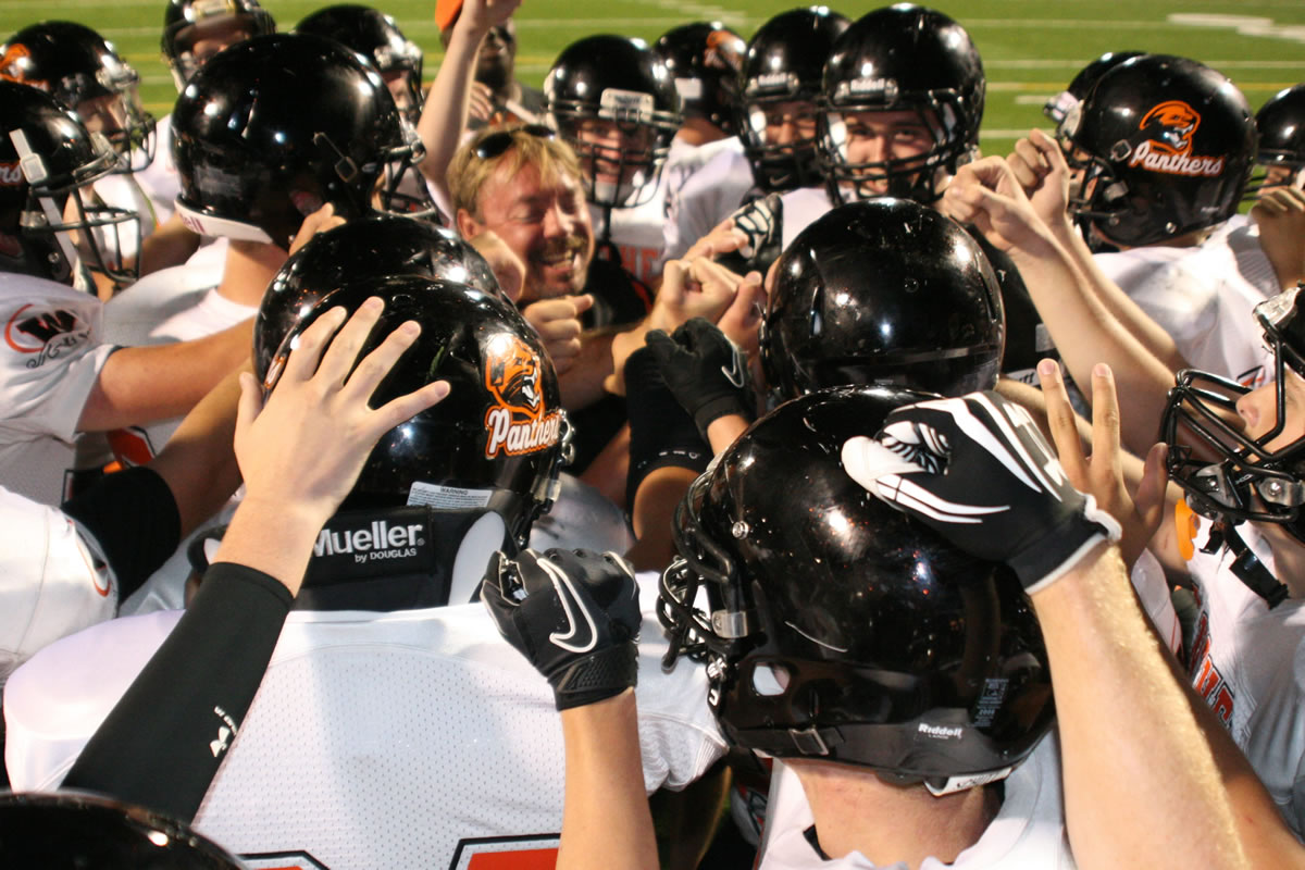 The Washougal High School football players celebrate with head coach Bob Jacobs after beating Hudson's Bay 50-0 Friday night, at Kiggins Bowl in Vancouver.