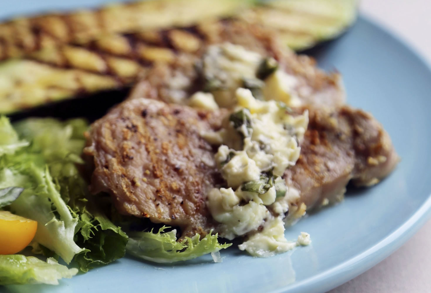 Pork Cutlets cook quickly and are accompanied by Zucchini and Oregano/Feta Butter.