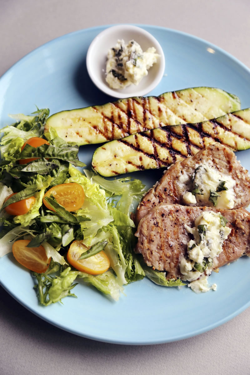 Pork cutlets cook quickly and are accompanied by zucchinie and oregano/feta butter. (Regina H.