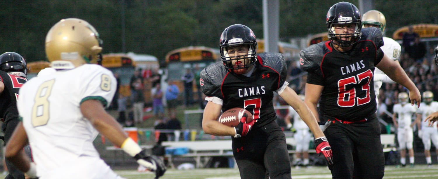 Camas High School senior Nate Beasley (7) gallops to the first of five touchdowns Friday, at Doc Harris Stadium.