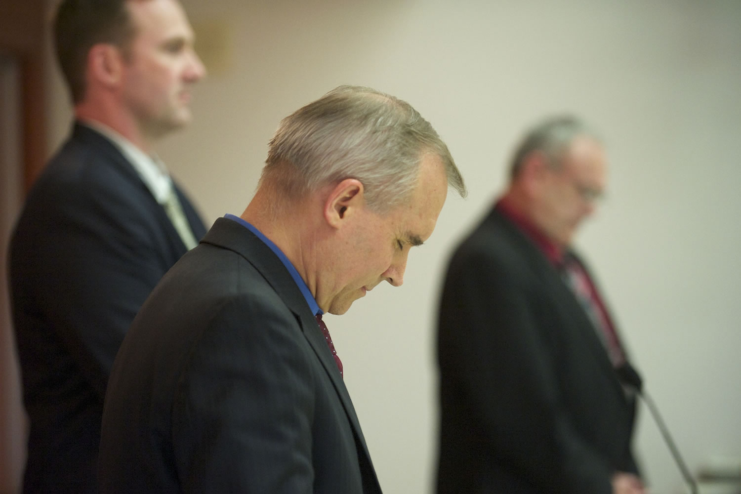 Clark County Commissioners David Madore, from front, Steve Stuart and Tom Mielke pause for prayer before the start of a commissioners meeting at the Clark County Public Services Center earlier this year.