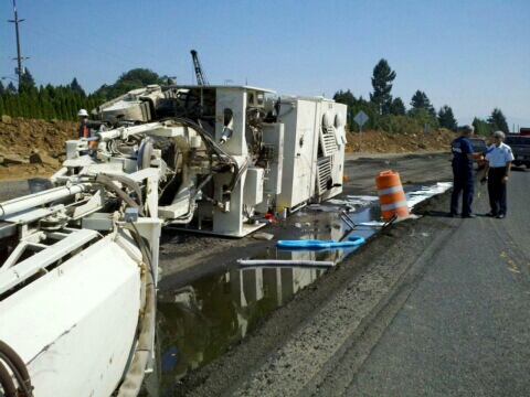 An asphalt grinder lies on its side on state Highway 14 in Washougal on Friday afternoon.
