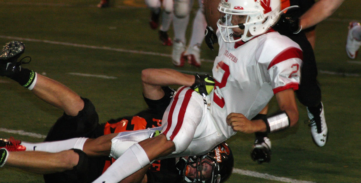 Bobby Jacobs traps the Fort Vancouver quarterback Friday, at Fishback Stadium.