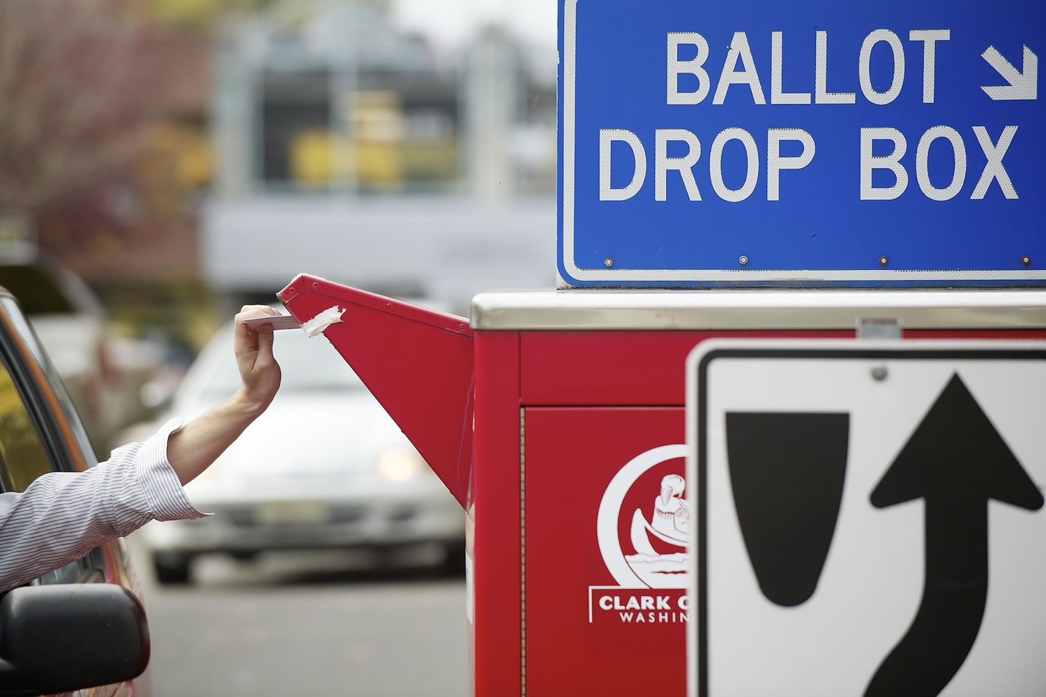 A voter slides a ballot into the drop box in downtown Vancouver in 2012.