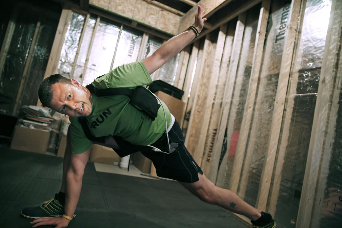 At his home in Plymouth, Minnesota, Peter Quimby completes the Insanity Workout, a hardcore physical fitness routine one can watch on video July 10.