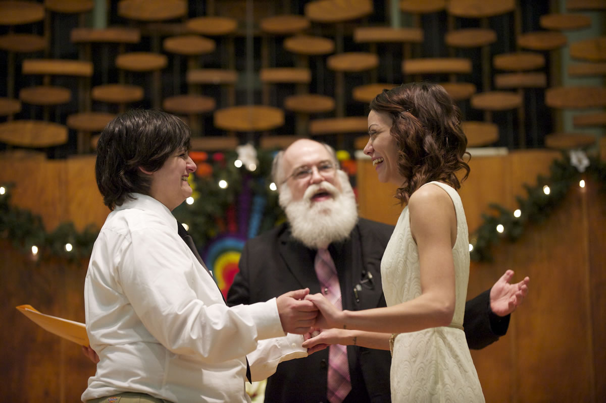 Rob Figley officiates at the marriage of Jessica Lee, 19, left, and Ashley Cavner, 21, both of Vancouver on Dec. 7, 2012, at the First Congregational Church in Vancouver. It is believed to be the first same-sex marriage legally recognized by Clark County.