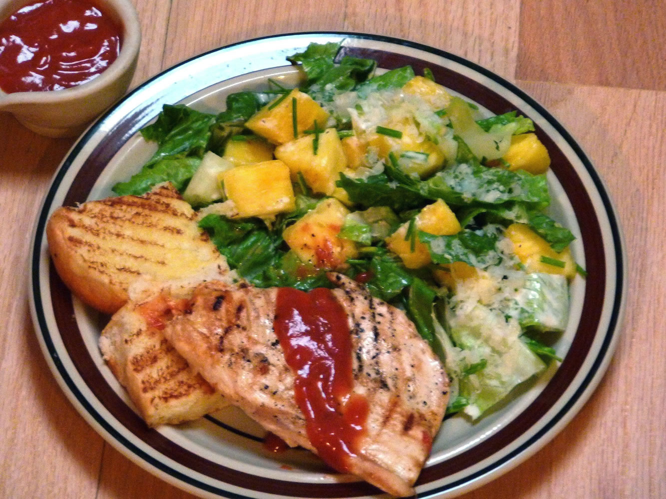 Hawaiian barbecued chicken is served with pineapple Caesar salad.