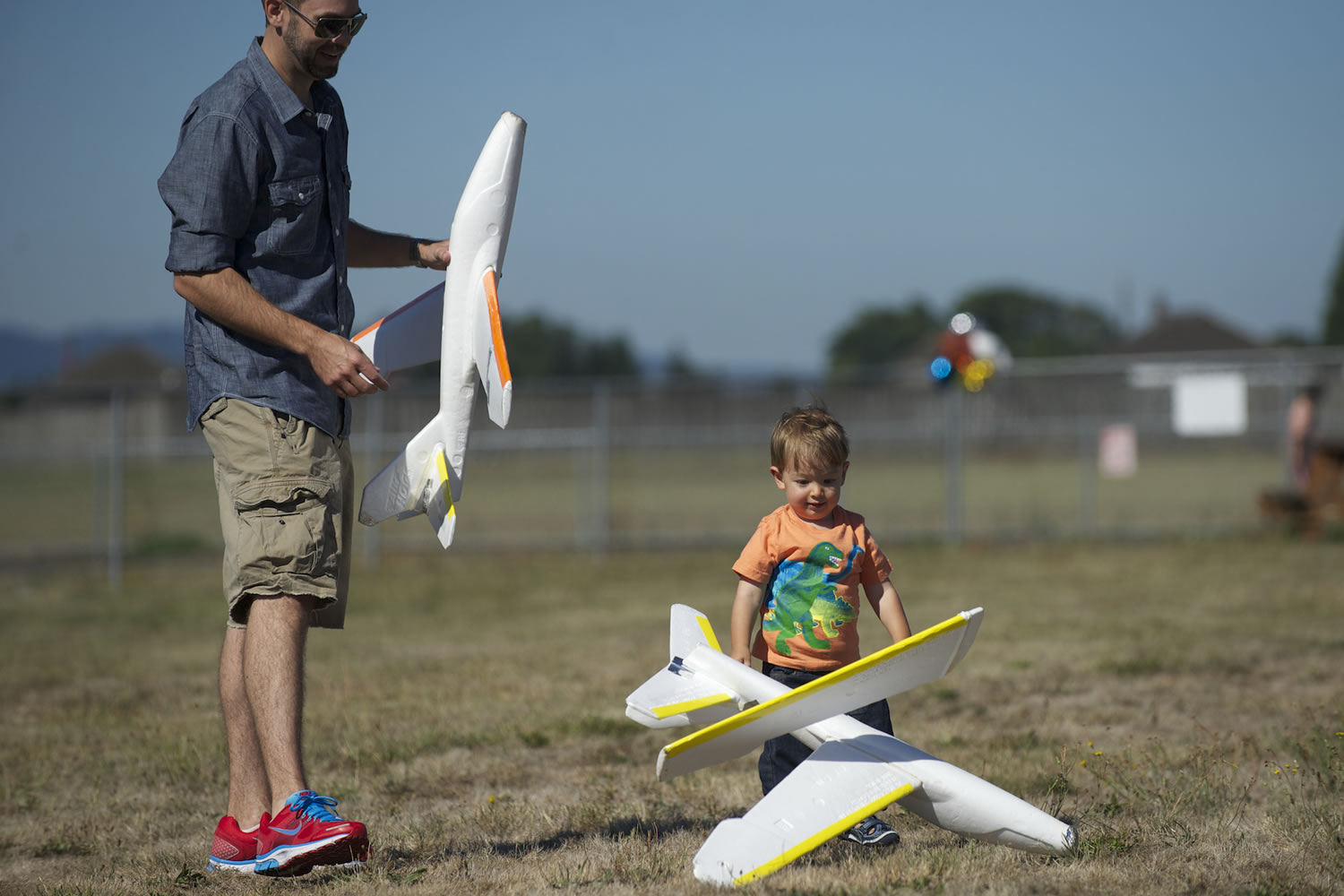Reid Isaacson and his son Ronan play with foam gliders during Pearson Field Education Center's Open Cockpit Day on Aug.