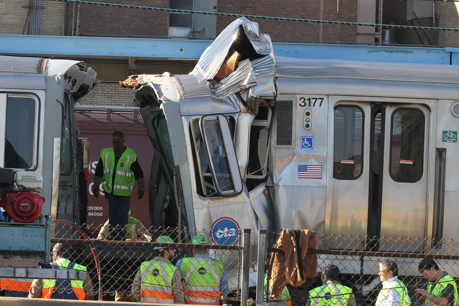 Emergency personnel investigate the scene Monday after a CTA train ran head-on into another train stopped at a Blue Line station in Forest Park, Ill.