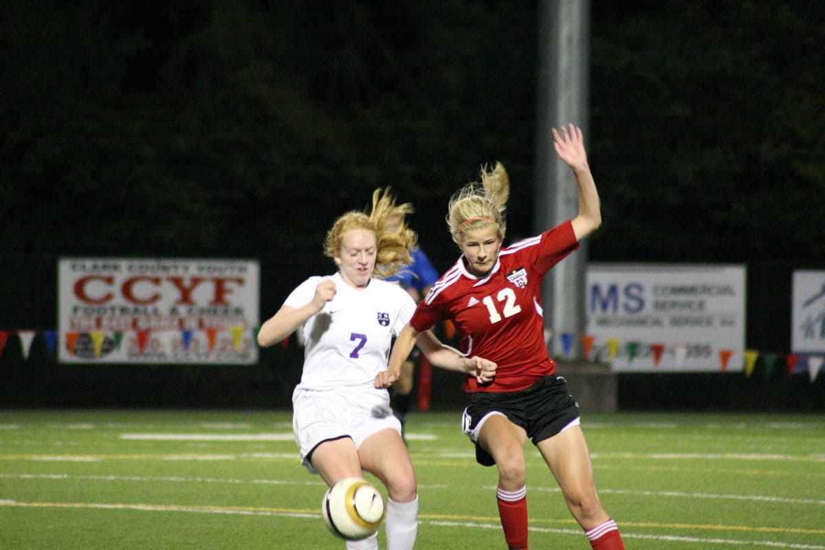 Camas junior Riley Allison (right) and a Columbia River Chieftain battle for the soccer ball Thursday, at Kiggins Bowl.