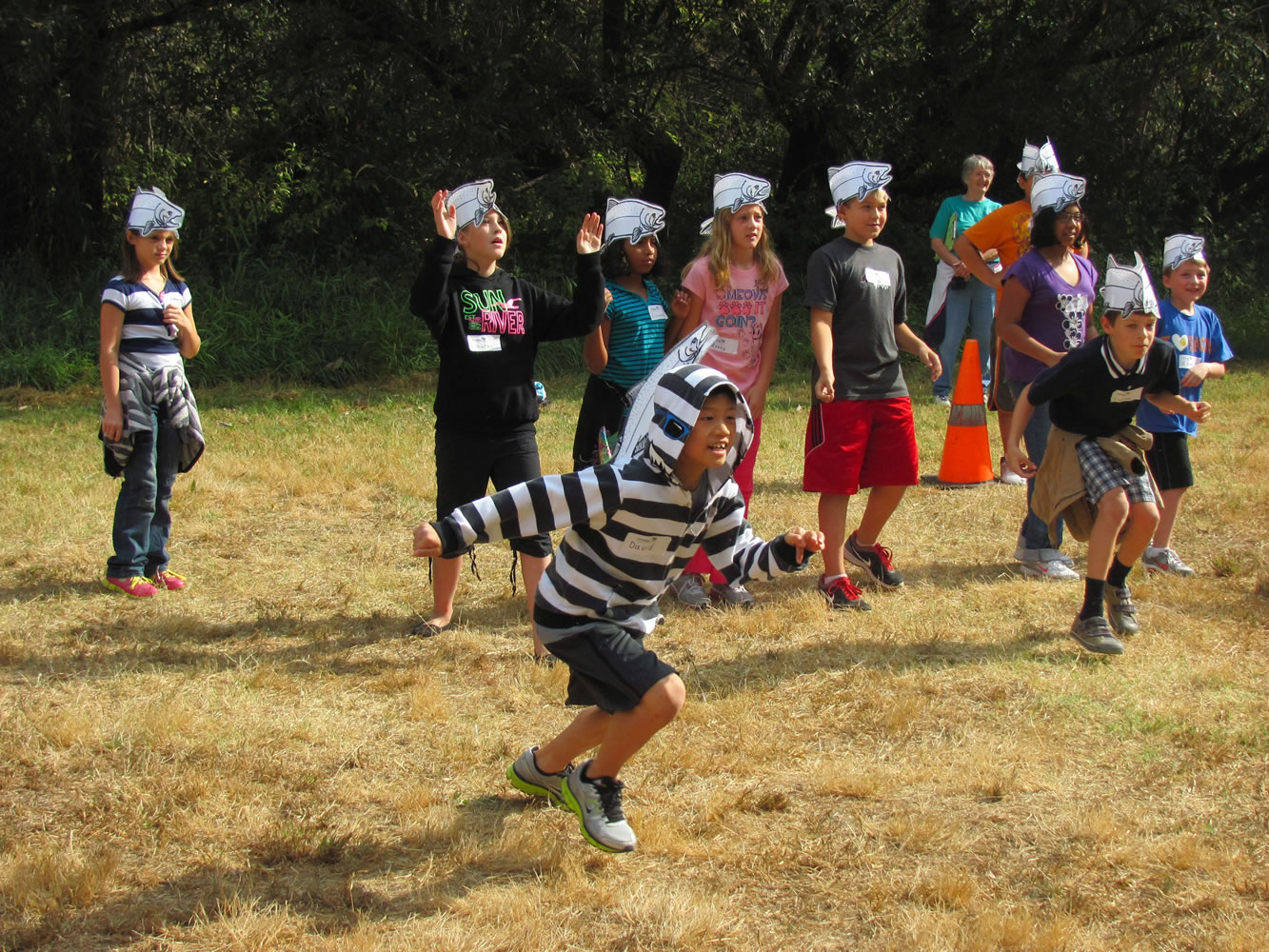 Fourth-grade students run through a salmon obstacle course on Friday as a part of the Columbia River Watershed Festival at Capt.