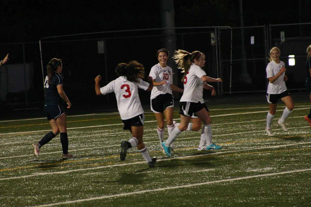 Anyssa DeVera runs up to hug Emily Ponce after the two Papermakers connected on the first goal of the game against Skyview Sept.
