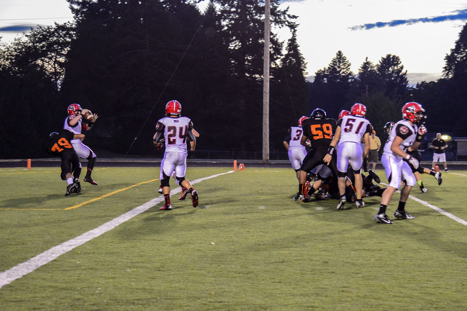 Washougal defensive lineman Caleb Economides blind sides R.A. Long quarterback Ryan Peerboom in the end zone to give the Panthers two points on a safety.