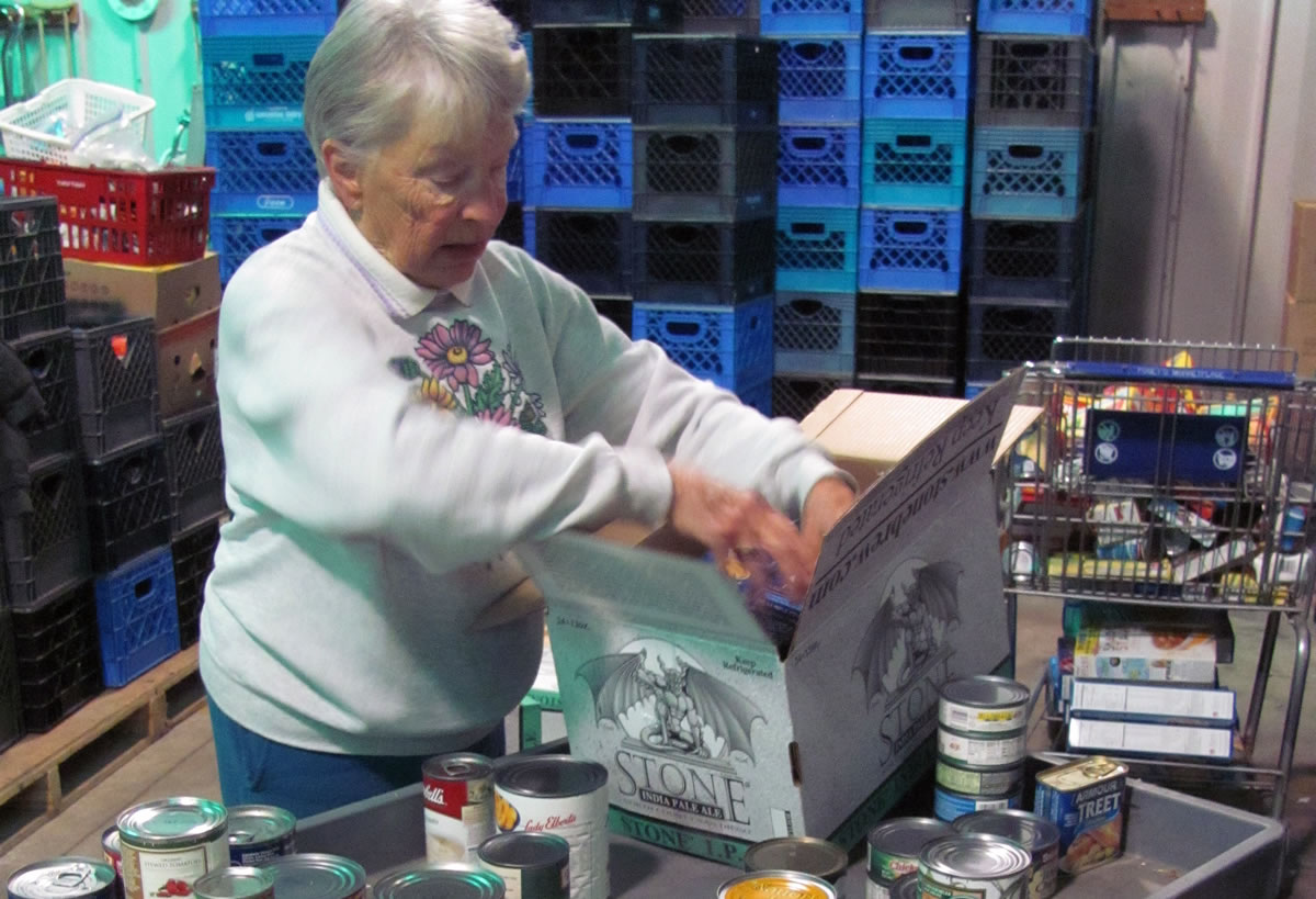 Faye Schanilec, a volunteer, sorts donations at the Inter-Faith Treasure House food bank. The Treasure House provides 45,000 to 65,000 pounds of food a month for area families. That includes monthly food boxes, USDA commodities, a backpack home program for children on weekends and meals served at the Lost &amp; Found Cafe. Public and private donations have decreased, and the Treasure House no longer receives goods from the Oregon Food Bank. iWe need food,i said Treasure House Executive Director Nancy Wilson.