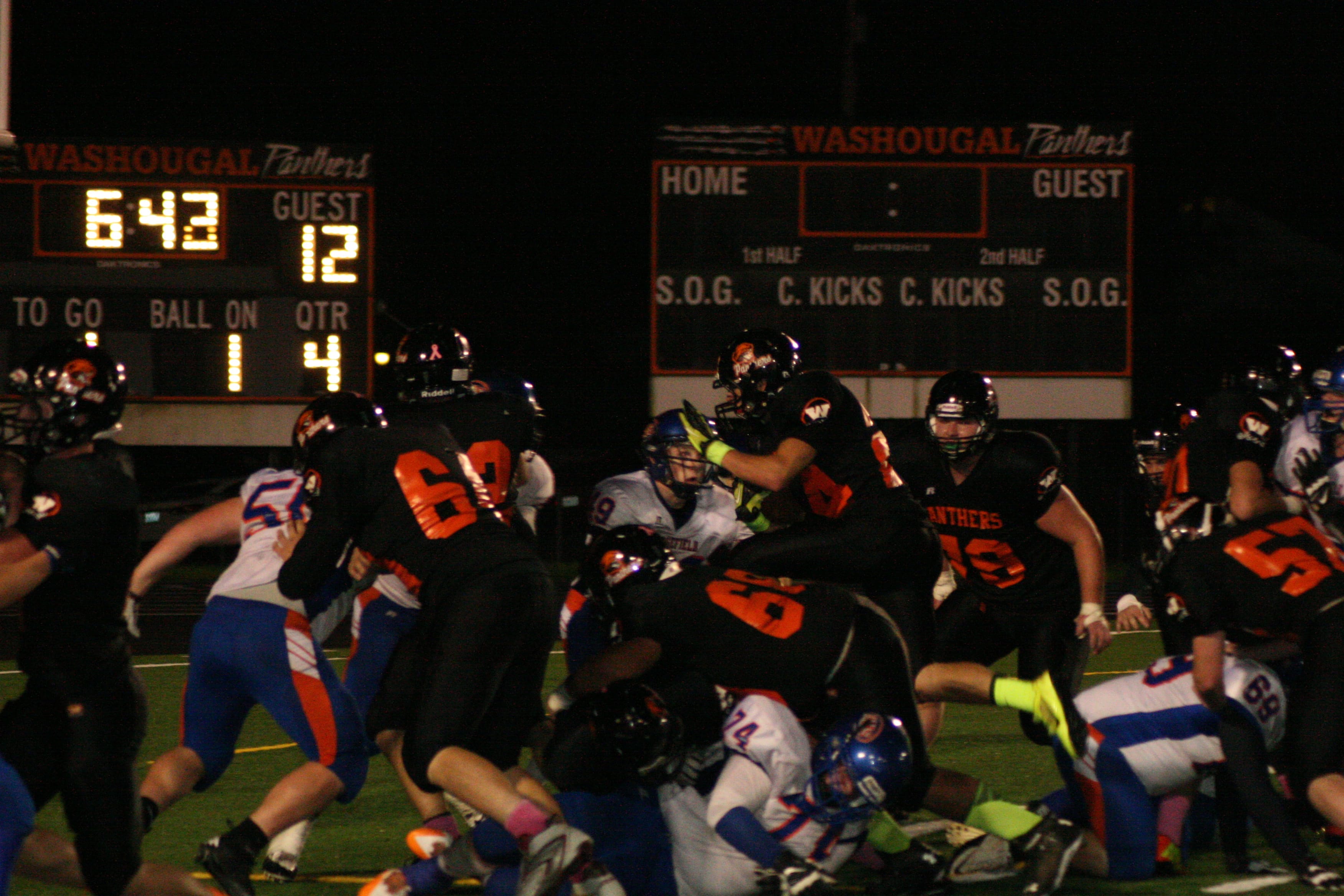 Offensive linemen for Washougal push Ridgefield off the goal line while Bobby Jacobs jumps over the pile to score one of his four touchdowns Friday, at Fishback Stadium.