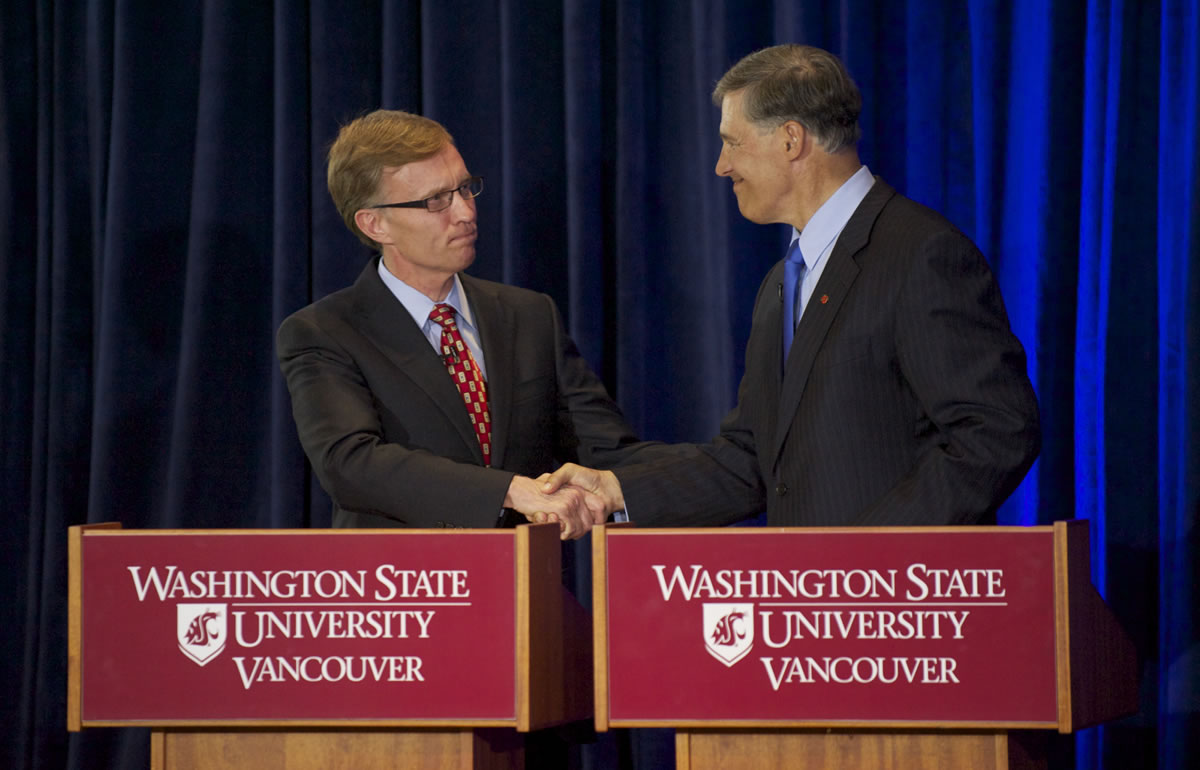 Rob McKenna, left, and Jay Inslee, candidates for governor of Washington, shake hands at the end of their debate Wednesday night at the Washington State University Vancouver campus.