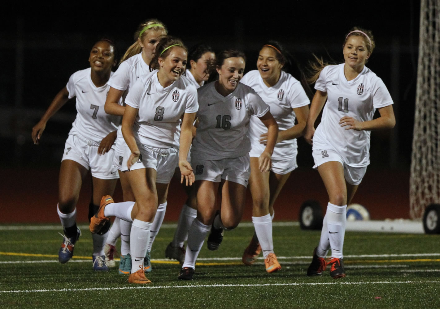 Union midfielder Melissa Foster (8) celebrates with her Titans teammates after scoring against Camas.