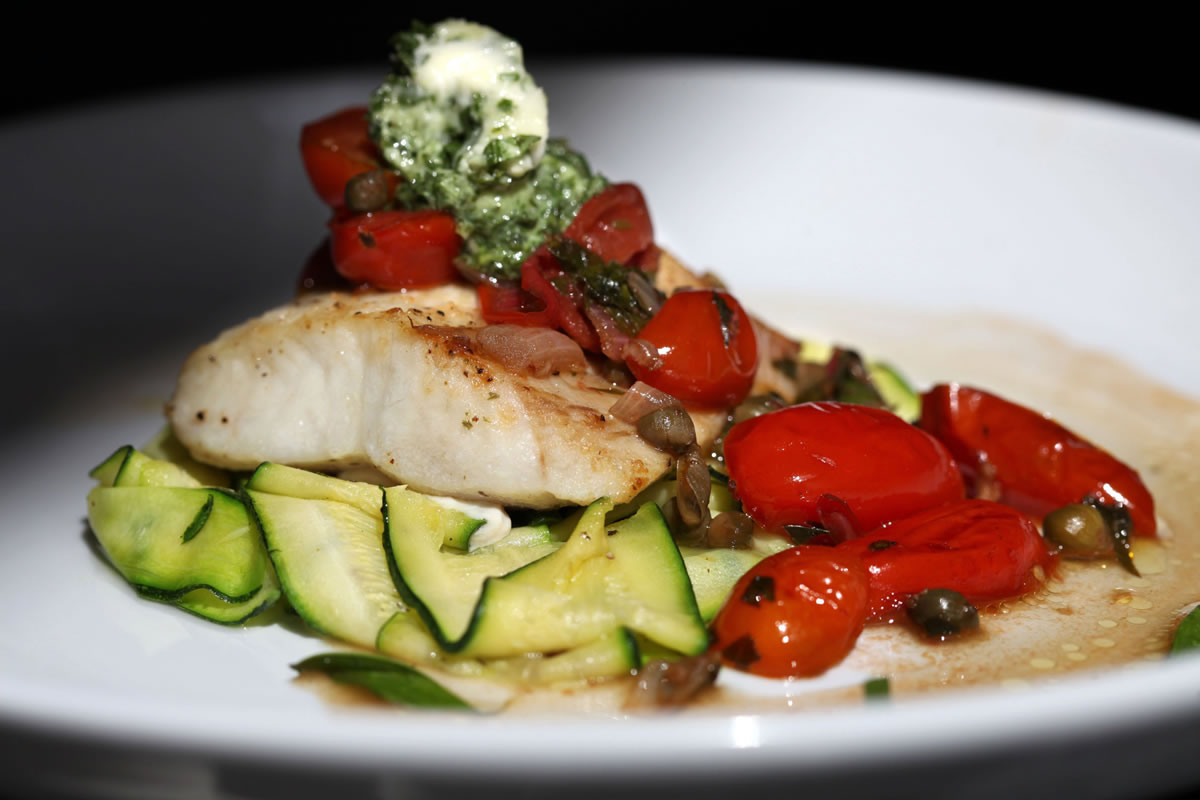 Broiled Mahi-Mahi With Basil Butter is served with lightly sauteed zucchini ribbons and grape tomatoes.