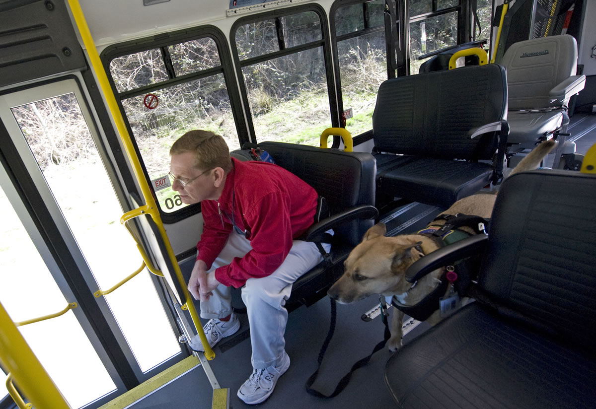 Harry Kiick of Vancouver rides a C-Van bus with his service dog, Sasha, in 2009.