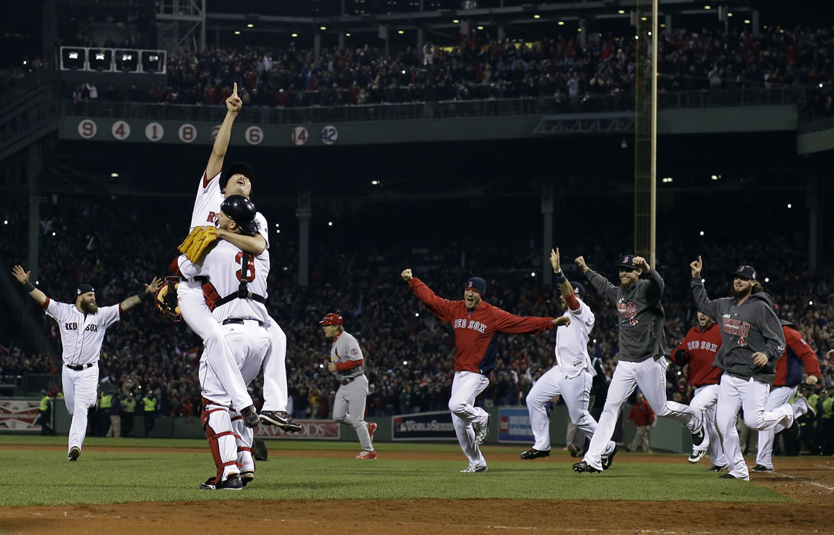 Sox relief pitcher Koji Uehara and catcher David Ross celebrate after getting the final out of the World Series.