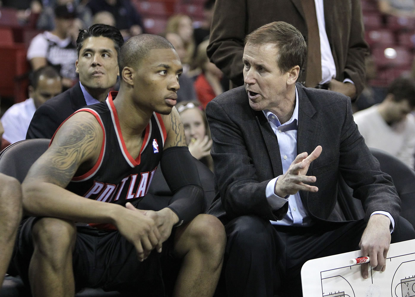 Portland Trail Blazers head coach Terry Stotts, right, talks with rookie guard Damian Lillard during halftime of an NBA preseason basketball game against the Sacramento Kings in Sacramento, Calif, Monday, Oct. 15, 2012.