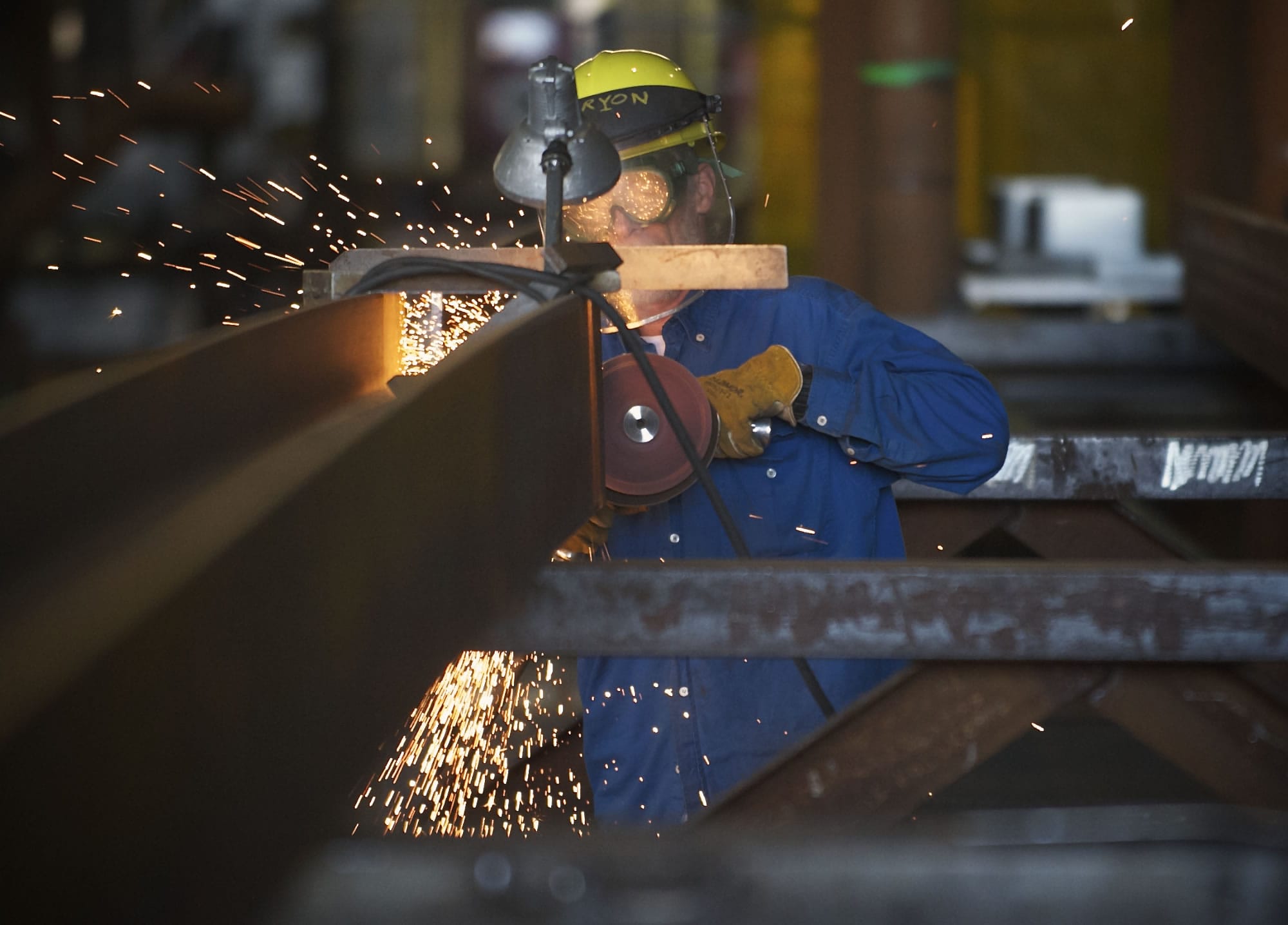 A worker uses a grinder inside Thompson Metal Fab, one of three Vancouver manufacturers that said the proposed bridge's lower height would have had a negative impact on their businesses.