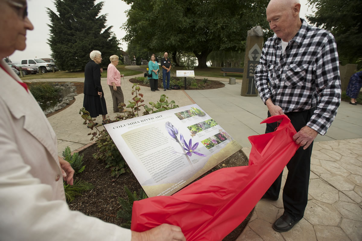 Ginny Frosh and Ted Durgan unveil one of three new interpretive panels honoring the Chinookan people Thursday at the Parkersville National Historic Site.