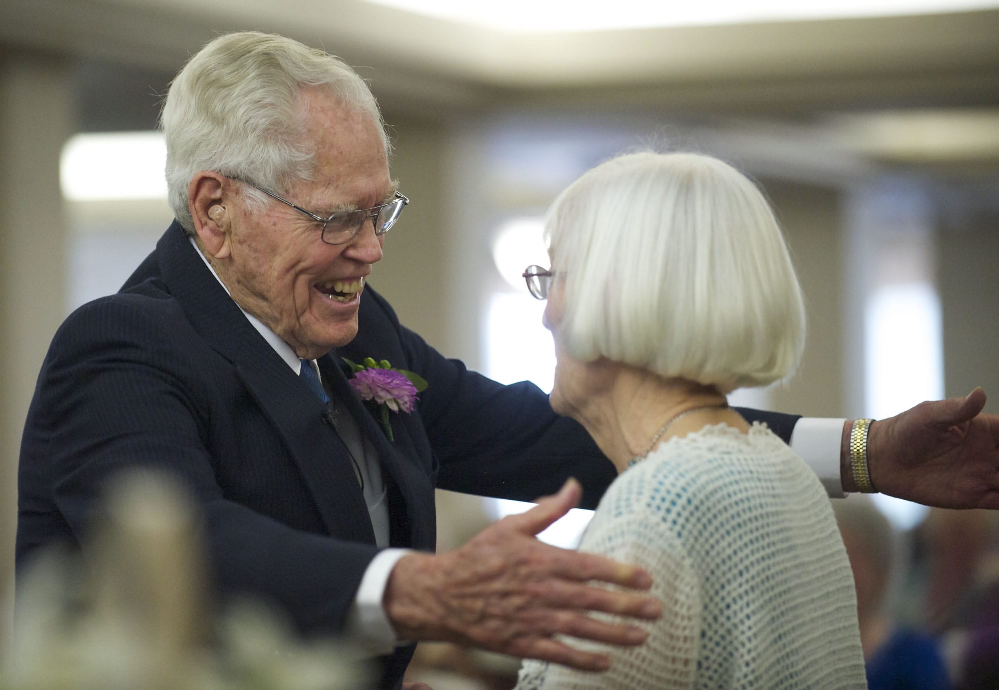 John Deurwaarder and his bride, Alta Lunsford, share a hug after Saturday's wedding.