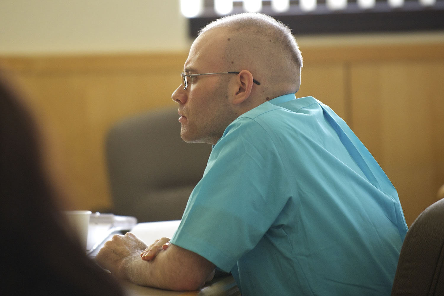 Michael Boswell listens to his former girlfriend answer questions from a prosecuting attorney Monday October 29, 2012 at the Clark County Courthouse in Vancouver, Washington.