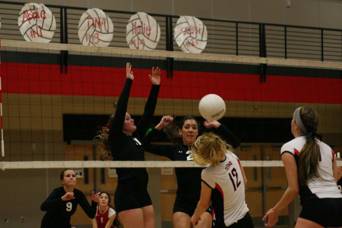 Camas seniors Abbie Younkin (11) and Lauren Neff (2) dunked the volleyball on a Union Titan.
