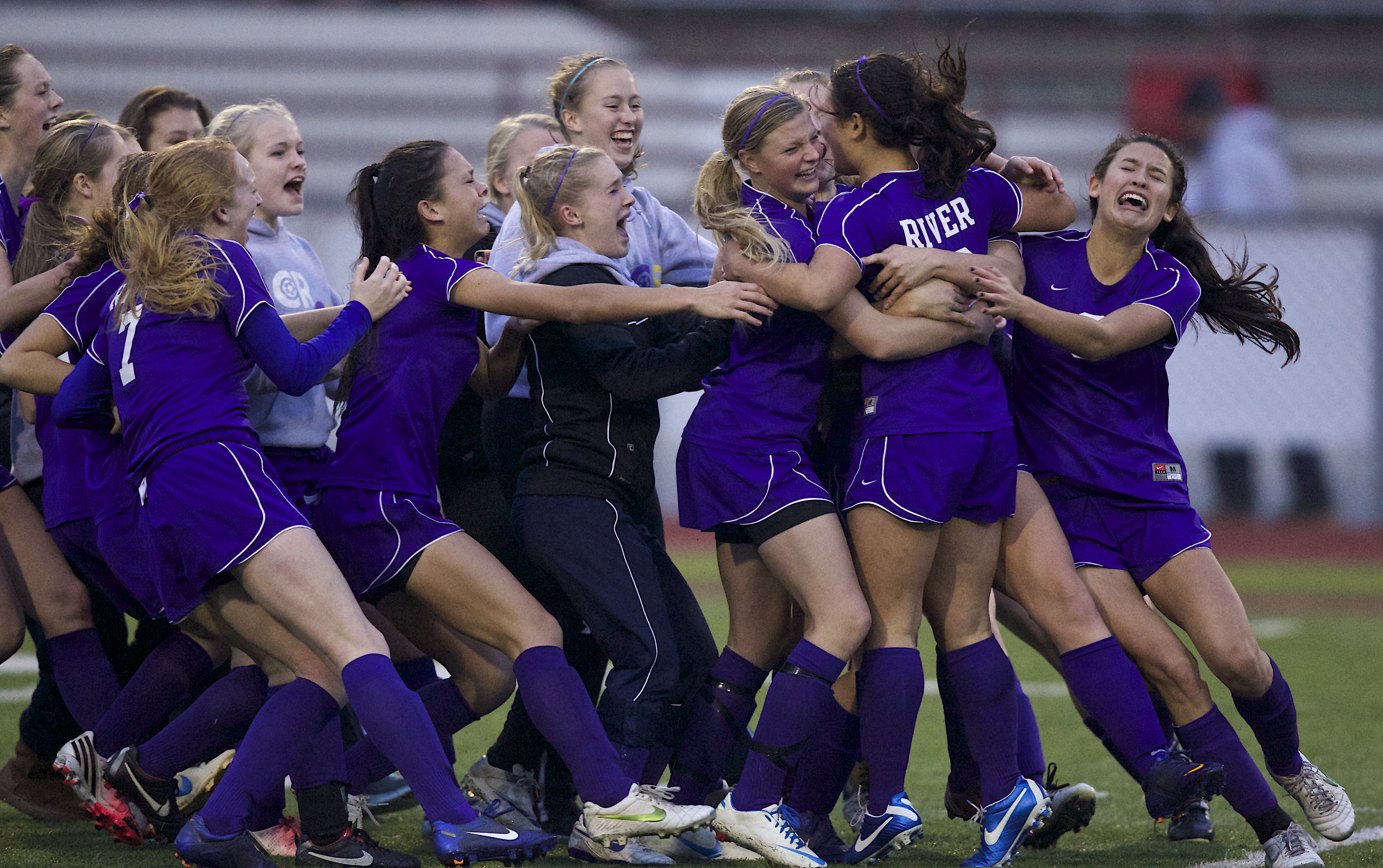 The Columbia River girls soccer team celebrates a 3A state semfiinal win over Liberty on penalty kicks.