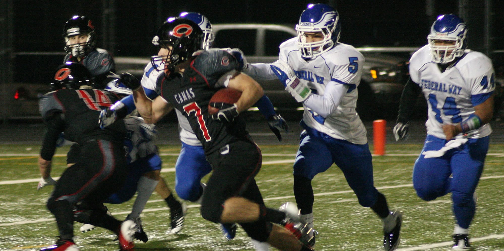 Nate Beasley cuts by three defenders and inches toward his fifth touchdown of the game Saturday, at Doc Harris Stadium.