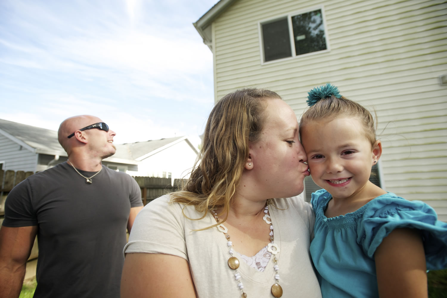 Brynley Verbeck, 4, shown with her mom, Jen Verbeck, fell out of her second-story bedroom window and was caught by attentive neighbor Nathaniel Forest, left.