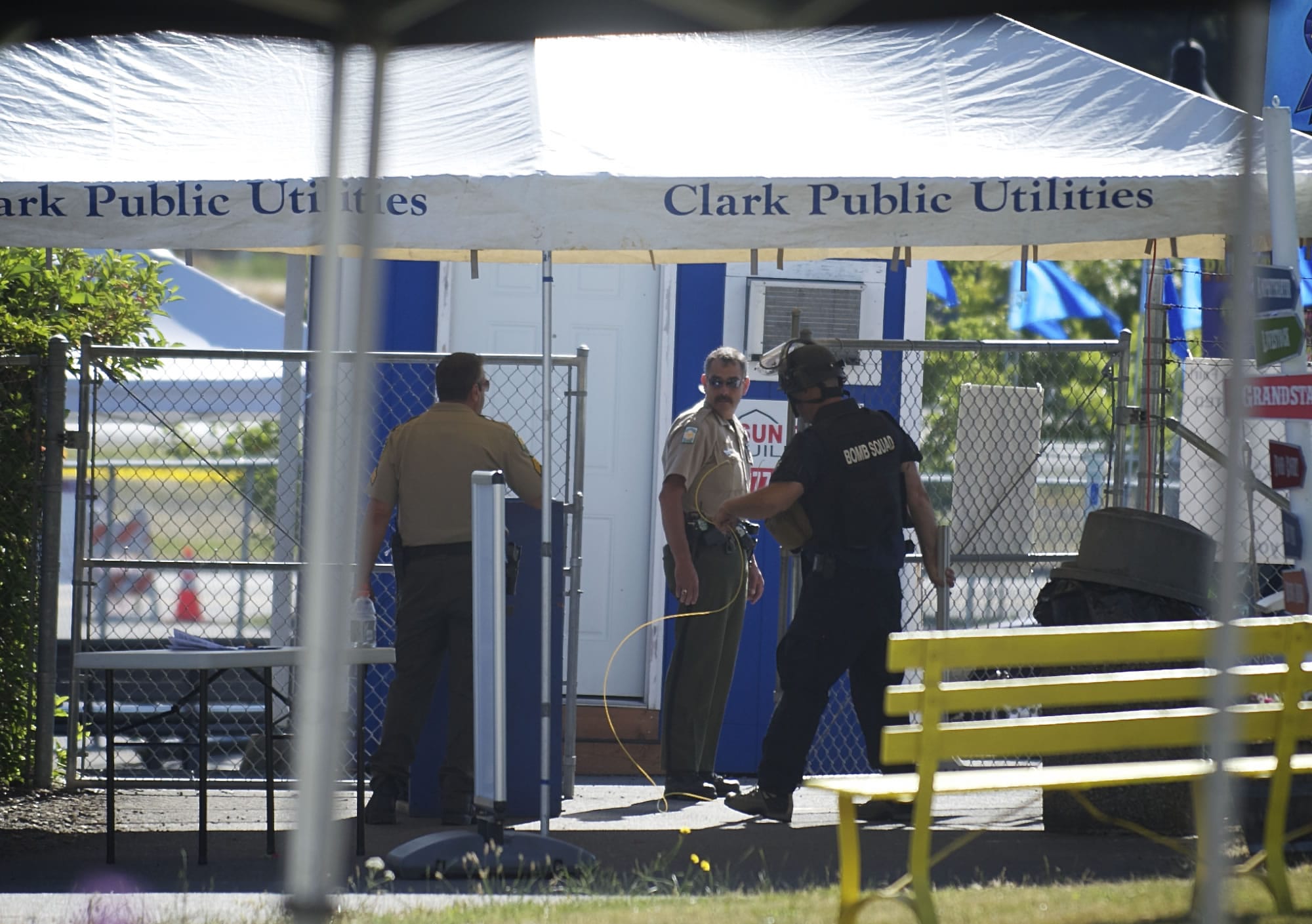 Clark County Sheriff's deputies and a member of the Metro Bomb Squad clean up after investigating two suspicious packages at the Clark County Fair on Friday.