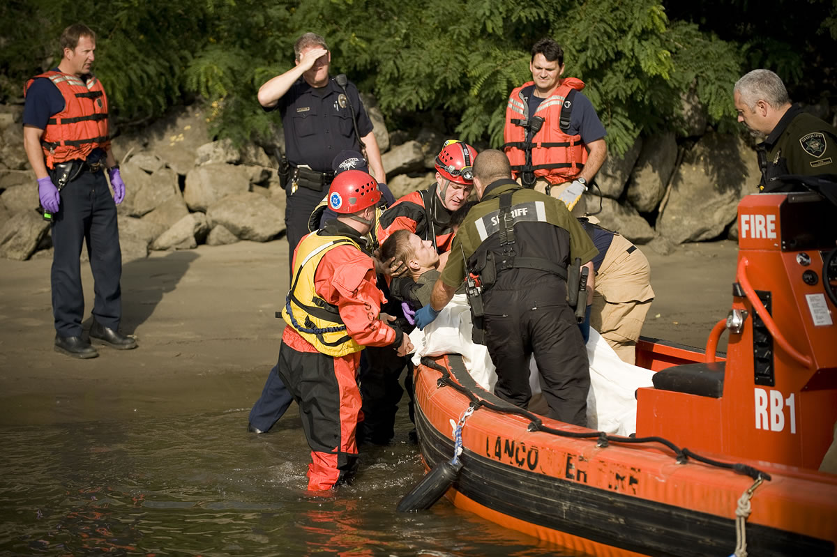Police, firefighters and paramedics respond to a man standing in the Columbia River near the Red Lion Hotel Vancouver at the Quay boat dock on October 16, 2011. The man, who appeared to be in a catatonic state, had to be pulled from the river by rescue swimmers and was transported to a local hospital.