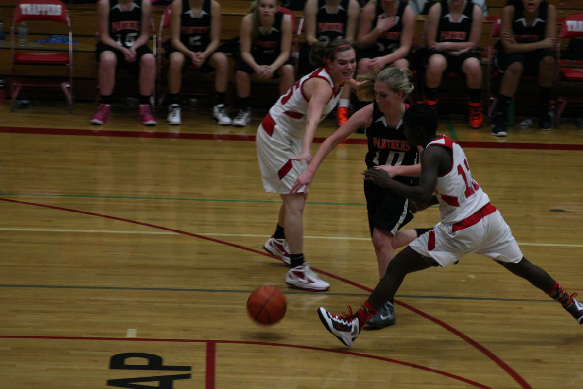 Megan Sharp cuts through two Trappers Thursday, at Fort Vancouver High School.
