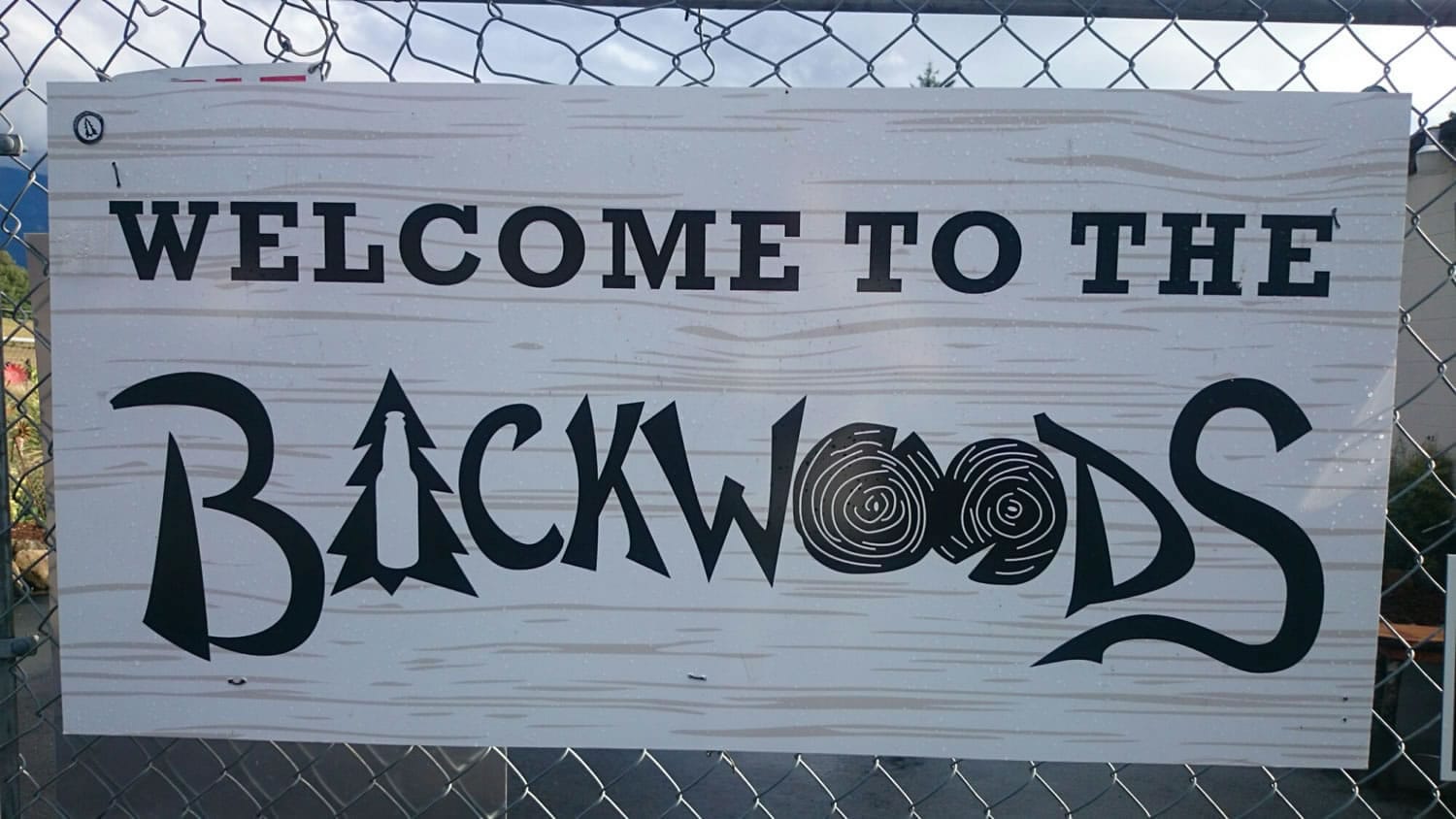 A sign hangs on the fence surrounding Backwoods Brewing's patio in Carson. The three-year-old brewery in the Columbia River Gorge is expanding so rapidly that production is moving to the Port of Skamania in Stevenson.